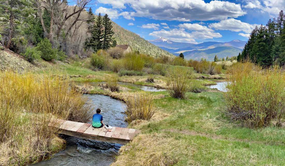 My nephew relaxing on a bridge over a small mountain stream – Pic taken 5/25/2024