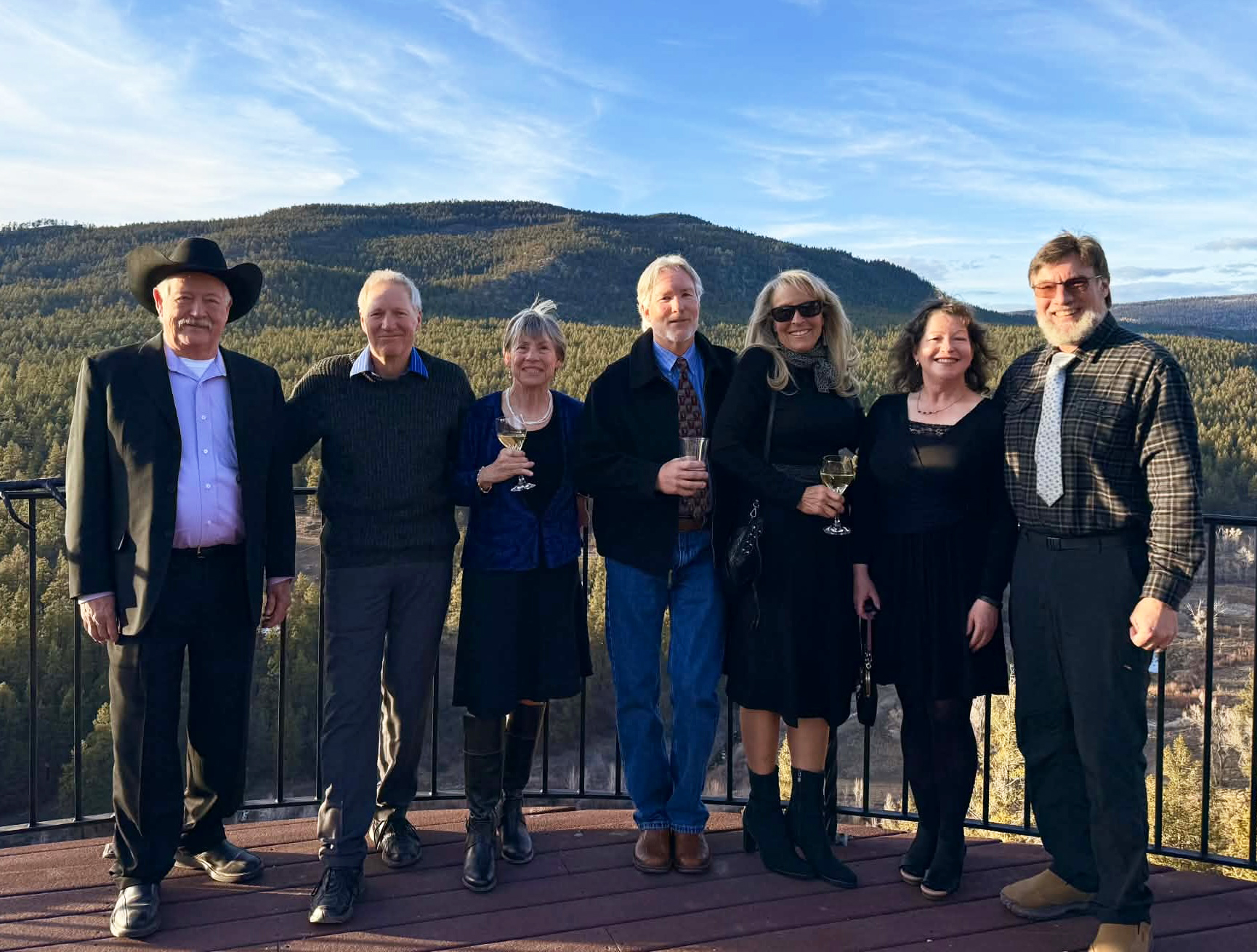 6 people standing on patio at sunset