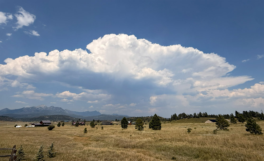 During this dry and warm period, it’s nice to see a cumulonimbus cloud dropping a few raindrops on our mountains! – pic taken 8/6/2026